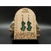 Machine embroidered earrings of the word Lucky in green with black border. Black hypoallergenic hooks.